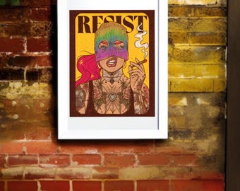 May include: A framed art print featuring a person with pink hair wearing a rainbow-colored knit balaclava, holding a lit cigarette with smoke rising. The person has extensive chest and arm tattoos. The word RESIST is printed in bold black letters.
