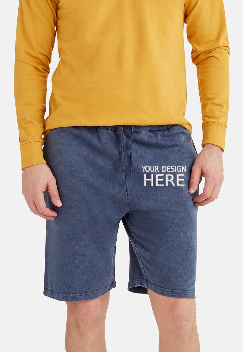 May include: A pair of blue drawstring shorts with the text "YOUR DESIGN HERE" printed on the front.