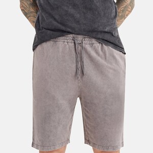 May include: A pair of grey drawstring shorts with a faded, vintage look.
