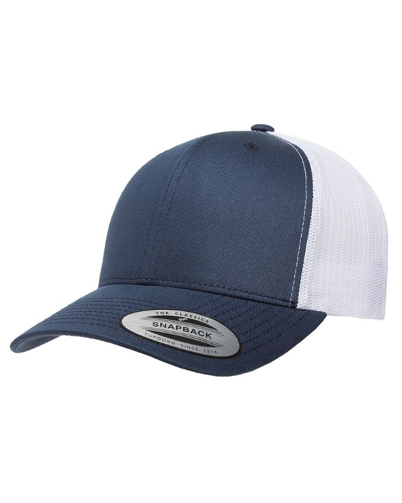 May include: A navy blue and white trucker hat with a mesh back. The hat has a curved brim and a snap closure. The hat has a label that says "The Classics" and "Snapback" with the text "Yupoong - Since 1974" underneath.