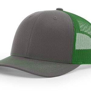 May include: A grey and green trucker hat with a mesh back. The hat has a curved brim and a structured crown.
