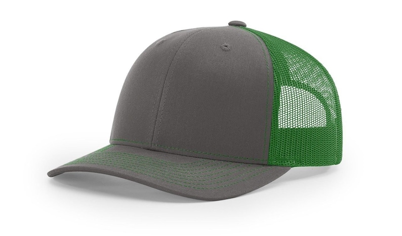 May include: A grey and green trucker hat with a mesh back. The hat has a curved brim and a structured crown.