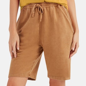 May include: Brown cotton shorts with a drawstring waist and side pockets.