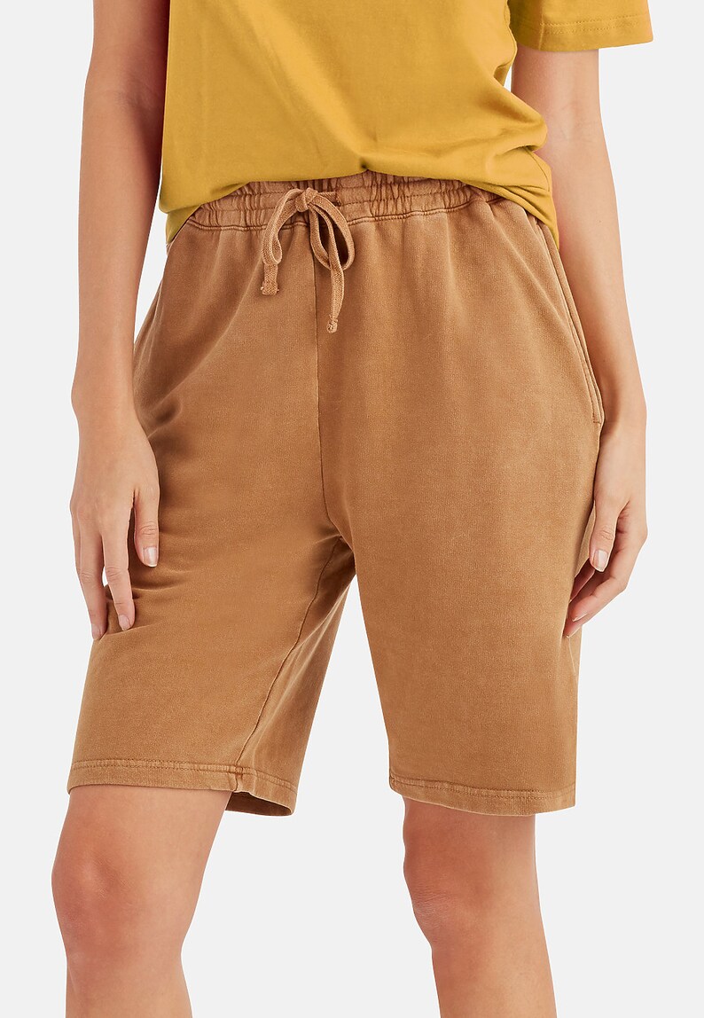 May include: Brown cotton shorts with a drawstring waist and side pockets.