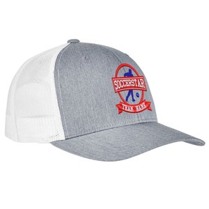 May include: Gray and white trucker hat with a red and blue embroidered logo that says "Soccerstar" and "Team Name".