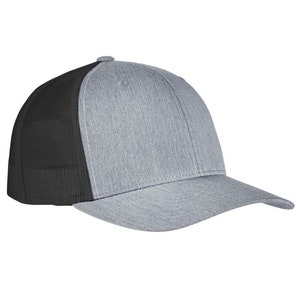 May include: A gray and black trucker hat with a mesh back. The hat has a curved brim and a structured crown.