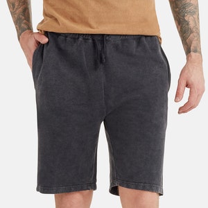 May include: Black drawstring shorts with a distressed look. The shorts have a relaxed fit and are made of a soft, comfortable fabric.