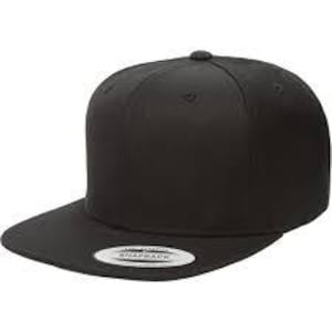 May include: A plain black flat-peak baseball cap with a structured front and a snapback fastening. The cap has a small, round button on the crown and a flat peak. The front of the cap has a white, circular tag with black text.