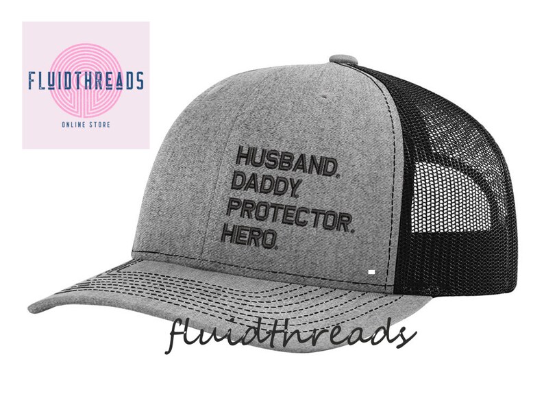 May include: Gray and black trucker hat with the text "Husband. Daddy. Protector. Hero." embroidered in black.