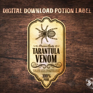 May include: A vintage-style potion label with a brown tarantula illustration. The label reads "Premium Quality Tarantula Venom" and "For use with only the most deadly spells and potions 100% Pure". The label is on a wood background.