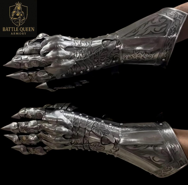 May include: Two silver gauntlets with articulated fingers and claw-like tips. The armour features detailed engraved patterns and is designed to protect the hand and forearm. The Battle Queen Armory logo is visible in the upper left corner.
