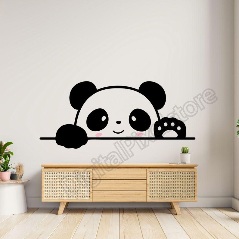 May include: Black and white panda bear peeking over a wall with a paw print on the right side. The panda has a cute, smiling face with black eyes and pink cheeks.