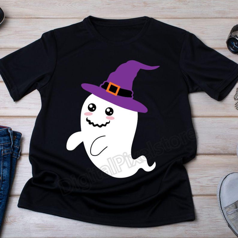 May include: Black t-shirt with a white ghost wearing a purple witch hat with an orange buckle. The ghost has a smiling face with two large eyes.