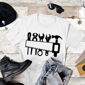 May include: White t-shirt with a black graphic of a saw and various tools. The graphic says "DIY".