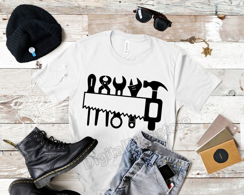 May include: White t-shirt with a black graphic of a saw and various tools. The graphic says "DIY".