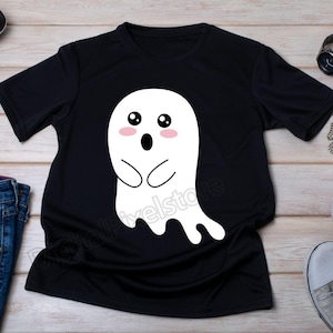 May include: Black t-shirt with a white cartoon ghost design. The ghost has big eyes, a surprised expression, and a cute, rounded shape.