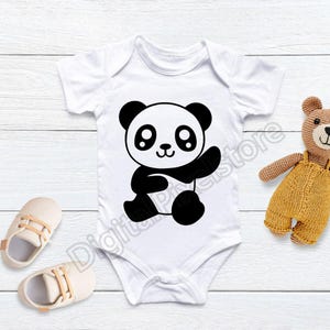 May include: White baby onesie featuring a black and white panda bear graphic. The panda is waving and has large eyes.