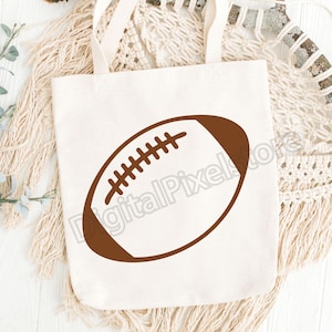Pode incluir: Uma bolsa de lona branca com um contorno marrom de uma bola de futebol americano.