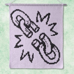 May include: A rectangular lavender wall hanging featuring a black pixelated graphic of two horseshoe magnets facing each other with radiating lines. The textile piece is suspended from a light-colored wooden dowel with a white string for hanging.
