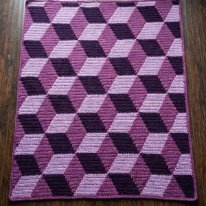 May include: A white ceramic mug with a black handle and the text "But First, Coffee" in a black, handwritten-style font. The mug is on a white surface.