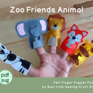 May include: A hand displays five felt finger puppets: a zebra, elephant, lion, fox, and giraffe. The puppets are colorful, with details like pink ears on the elephant and a brown mane on the lion. Text at the top reads "Zoo Friends Animal".