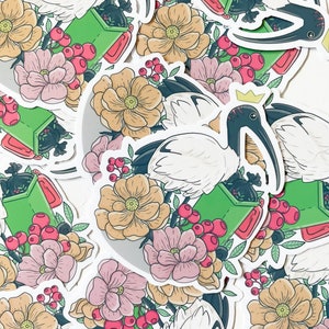 May include: A set of stickers featuring white ibises with green recycling bins and red berries. The ibises are depicted with a crown and are surrounded by flowers.