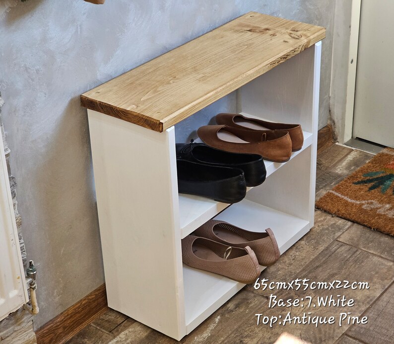 May include: White shoe rack with a wooden top. The rack has two shelves and is 65cm x 55cm x 22cm. The base is white and the top is antique pine.