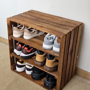 Side view of wooden crate-style shoe rack with three shelves – rustic handmade furniture for home storage.