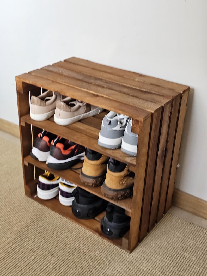 Side view of wooden crate-style shoe rack with three shelves – rustic handmade furniture for home storage.