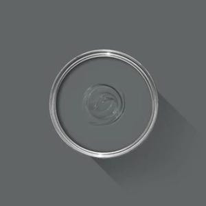 May include: An overhead view of a partially open, round, silver paint can filled with gray paint. The paint has a swirl pattern in the center. The can casts a shadow on the gray surface.