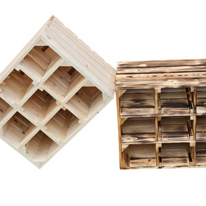 May include: Two wooden wine racks. One is natural wood, the other is a darker, burnt wood. Each rack has nine compartments. The natural wood rack is angled, while the burnt wood rack is upright.