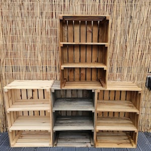 May include: Three wooden shelves made from repurposed crates. The shelves are stacked on top of each other and have a rustic, farmhouse style.
