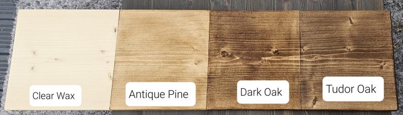 May include: Four wood samples stained in different colors: clear wax, antique pine, dark oak, and tudor oak.