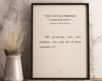 May include: A black framed print with a white background and black text. The text reads "THE LITTLE PRINCE" by Antoine de Saint-Exupéry. The quote reads "All grown-ups were once children... but only few of them remember it."