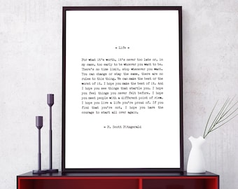May include: A black framed print with a white background and black text. The text is a quote about life by F. Scott Fitzgerald. The print is hanging on a wall above a red shelf with black trim.