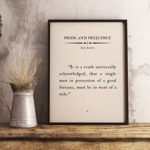 May include: A black framed print with a white background and black text. The text reads "Pride and Prejudice" by Jane Austen. The quote reads "It is a truth universally acknowledged, that a single man in possession of a good fortune, must be in want of a wife."