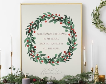 May include: A printable art print with a Christmas wreath and the quote "I will honor Christmas in my heart, and try to keep it all the year." by Charles Dickens. The print is framed in a gold frame and is displayed on a white mantel with candles and greenery.