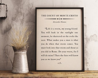 May include: A framed print with a white background and black text. The text is a quote from "The Count of Monte Cristo" by Alexandre Dumas. The quote reads: "Life is a storm, my young friend. You will bask in the sunlight one moment, be shattered on the rocks the next. What makes you a man is what you do when that storm comes. You must look into that storm and shout as you did in Rome. Do your worst, for I will do mine! Then the fates will know you as we know you" 175.