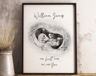 May include: Black and white ultrasound image of a baby in the womb. The image is framed and has the text "William Jones" and "The first time we saw you" printed below the image.