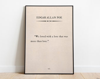 May include: A black framed print with a beige background featuring a quote by Edgar Allan Poe: "We loved with a love that was more than love."