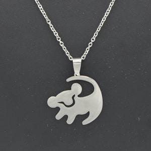 May include: A silver necklace with a pendant shaped like the lion from the film The Lion King.