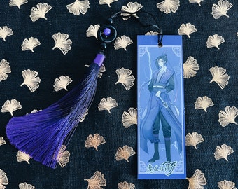 May include: A purple and black tassel bookmark with a blue and white illustration of a character from the anime "Mo Dao Zu Shi". The bookmark features the text "魔道祖师" in Chinese characters.