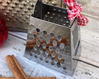 Premium Photo  Chocolate cinnamon nuts and a grater on a wooden table