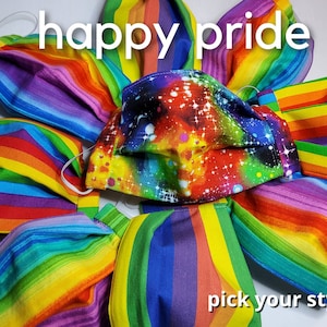 May include: A collection of rainbow-colored fabric face masks with different patterns, including stripes and a galaxy print. The text "happy pride" and "pick your style" are visible in the image.