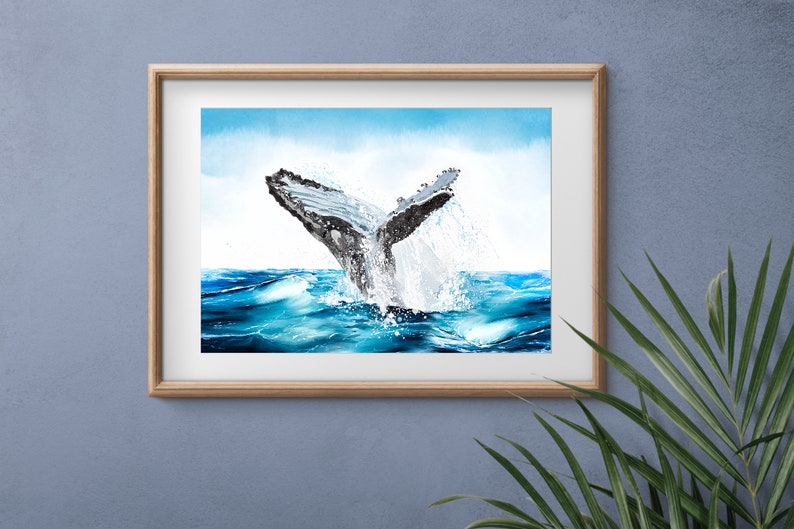 May include: A watercolor painting of a whale tail breaching the surface of the ocean. The water is a vibrant blue and the whale is gray with black markings. The sky is a light blue with white clouds.