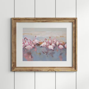 May include: A framed painting of a group of pink flamingos standing in a shallow body of water. The flamingos are reflected in the water, and the background is a soft, muted blue.