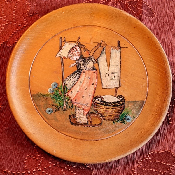 Hand Painted Wooden Display Plate of “Girl Hanging out Wash”