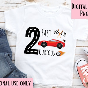 May include: White t-shirt with a black number 2, a red race car, and the text "Fast & Curious".