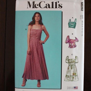 May include: A sewing pattern for a dress and two tops. The pattern includes multiple views and simple instructions. The dress is pink with white polka dots and has a square neckline. The tops are both floral patterned and have a square neckline. The pattern is designed and printed in the USA.