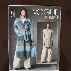 May include: Vogue Patterns V1758 sewing pattern featuring a woman in a long coat with a belt and wide-leg pants. The pattern also shows a sleeveless jacket and pants. The Vogue logo is at the top right.